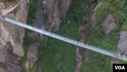 How safe are glass walkways, skywalks and bridges? New glass suspension bridge in China is 980 feet long, 600 feet high, and absolutely terrifying. (FILE PHOTO) 