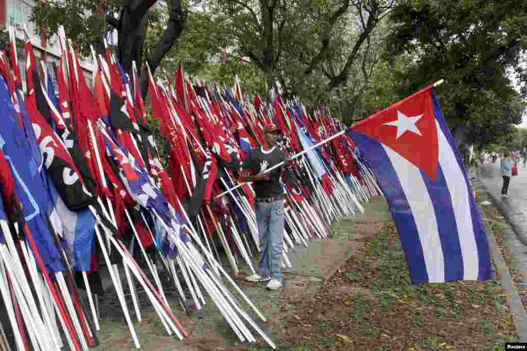 A man holds a Cuban flag after a May Day parade in Havana, May 1, 2015.