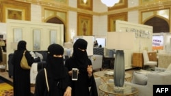 FILE - Saudi women wear the mandatory abaya, or loose-fitting gown, over their clothes in Jeddah, Saudi Arabia, Nov. 8, 2017. Rumors are circulating that a mixed-gender nightclub that does not require women to wear loose robes has opened in the city.