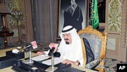 Saudi King Abdullah addresses the nation from his office at the Royal Palace in Riyadh, March 18, 2011