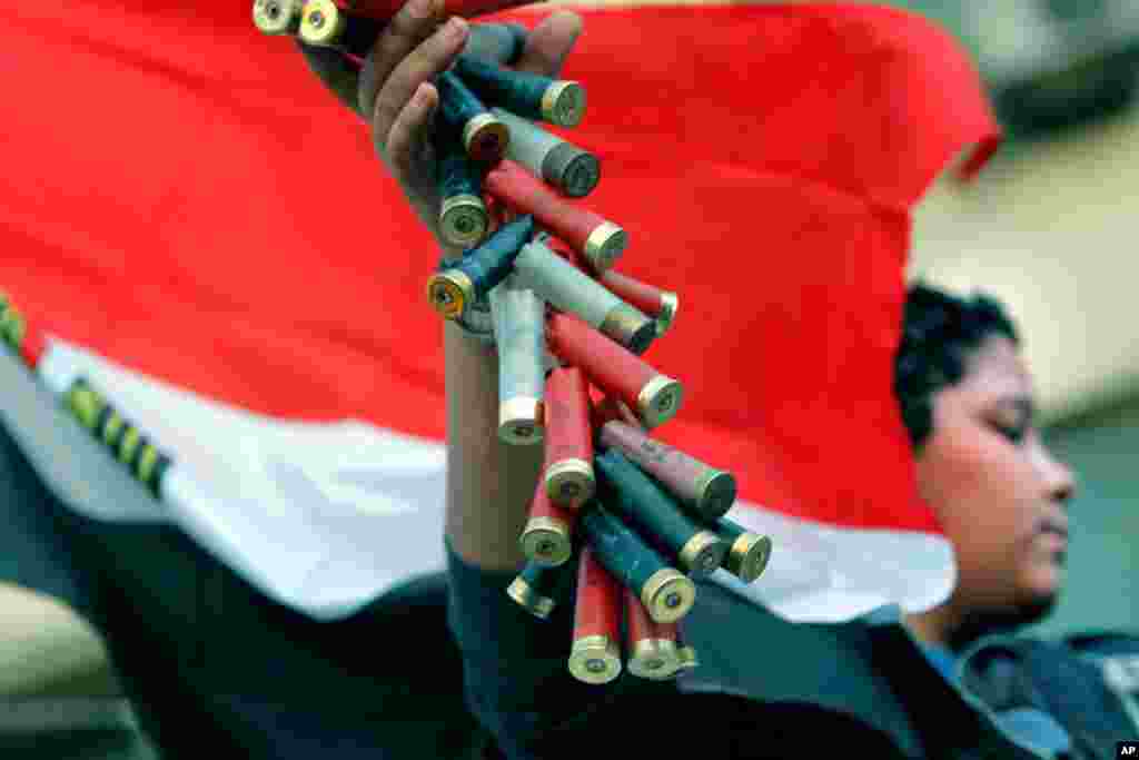 A protester displays used shotgun shells he said were used in recent clashes in Tahrir Square, during events to mark the second anniversary of former President Hosni Mubarak's resignation, February 11, 2013.