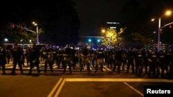 Police in riot gear block a roadway to stop demonstrators from entering a neighborhood as they protest the police shooting of Keith Scott in Charlotte, North Carolina, U.S., September 25, 2016.