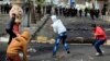 Egyptian protesters throw stones at riot police during clashes near a state security building in Port Said, March 7, 2013.