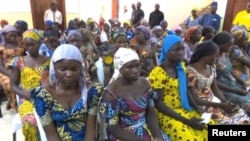 A still image taken from video shows a group of girls, released by Boko Haram jihadists after kidnapping them in 2014 in the north Nigerian town of Chibok, sitting in a hall as they are welcomed by officials in Abuja, Nigeria, May 7, 2017. 