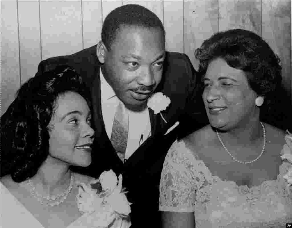 Martin Luther King, Jr. chats with his wife, Coretta, and civil rights champion Constance Baker Motley before the start of an S.C.L.C. banquet, Birmingham, Alabama, August 9, 1965.