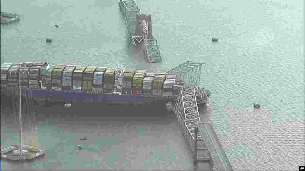 Parts of the Francis Scott Key Bridge remain after a container ship collided with a support, March 26, 2024 in Baltimore. (WJLA via AP)