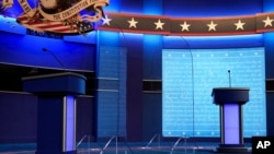 Clear protective panels stand on stage between lecterns for President Donald Trump and Democratic presidential candidate, former Vice President Joe Biden, ahead of their debate at Belmont University, in Nashville, Tennessee, Oct. 21, 2020.