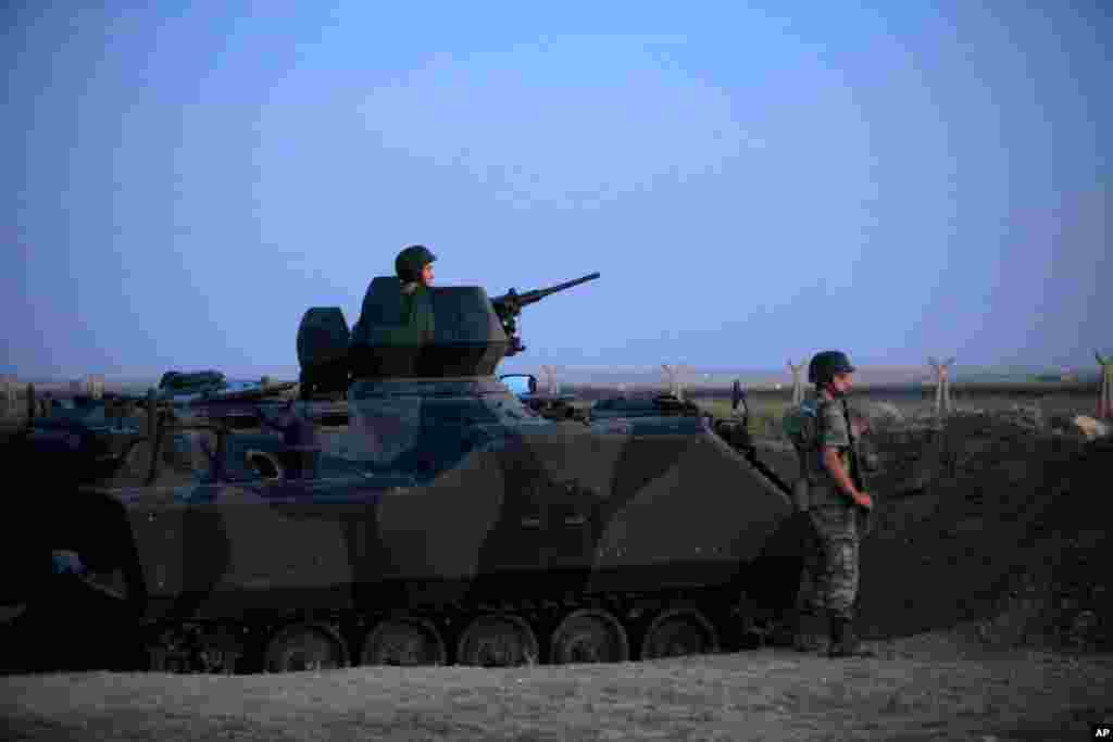Turkish military stand near the Turkey-Syria border in Akcakale, Turkey, October 5, 2012.
