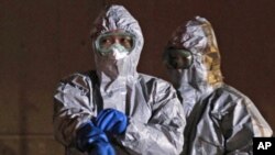 Officials in protective gear near the Fukushima Daiichi nuclear plant, in Koriyama, March 13, 2011