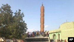 Sudanese people celebrate in the streets of Khartoum after ruling generals and protest leaders announced they have reached an agreement on the disputed issue of a new governing body on Friday, July 5, 2019. The deal raised hopes it will end a…