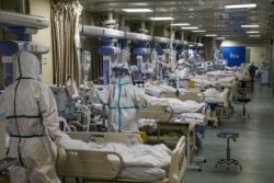 FILE - Medical workers in protective suits attend to novel coronavirus patients at the intensive care unit (ICU) of a designated hospital in Wuhan, Hubei province, China, Feb. 6, 2020. (Credit: China Daily)
