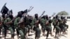 FILE - Hundreds of al-Shabab fighters perform military exercises in the Lafofe area, south of Mogadishu, in Somalia, Feb. 17, 2011. 