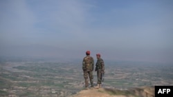 FILE - Afghan National Army (ANA) soldiers keep watch in Dand-e-Ghori district in Baghlan province on March 15, 2016, following weeks of heavy battles to recapture the area from Taliban militants.