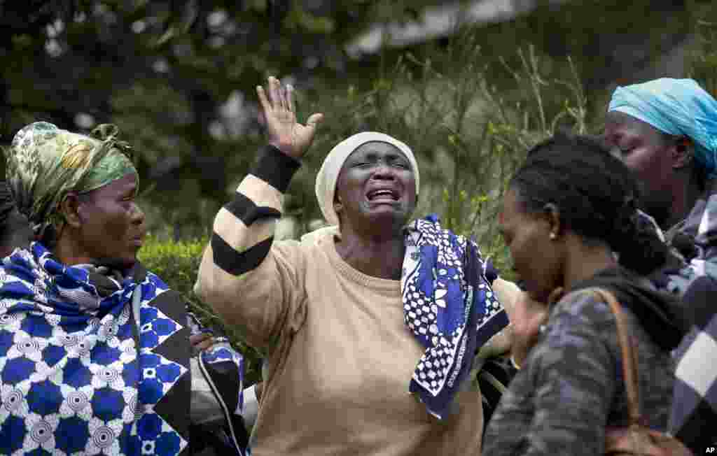 Mary Italo, center, grieves with other relatives for her son Thomas Abayo Italo, 33, who was killed in the Westgate Mall attack, as they wait to receive his body at the mortuary in Nairobi, Kenya, Sept. 25, 2013. 