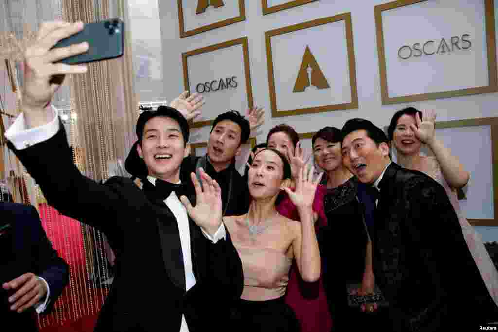 The cast of "Parasite" pose for a selfie on the red carpet during the Oscars arrivals at the 92nd Academy Awards in Hollywood, Los Angeles, California, Feb. 9, 2020.