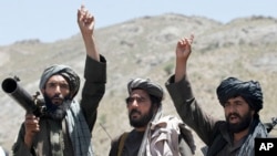 FILE - Taliban fighters react to a speech by their senior leader in the Shindand district of Herat province, Afghanistan. 