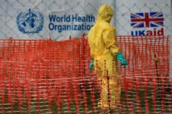FILE - A person dressed in Ebola protective apparel is seen inside an Ebola care facility at the Bwera general hospital near the border with the Democratic Republic of Congo in Bwera, Uganda, June 14, 2019.