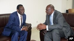 Dioncounda Traore (L), the new interim leader talks with Cheick Mohamed Abdoulaye Souad, aka Modibo Diarra, new prime minister, in Koulouba. Mali's former junta arrested two more politicians as the new interim prime minister weighs the make-up of a unity