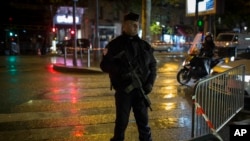 A French police officer stands guard near the Bataclan concert hall in Paris, Saturday, Nov. 12, 2016. The hall was among venues targeted a year ago by terrorists in coordinated attacks that left 130 people dead. 