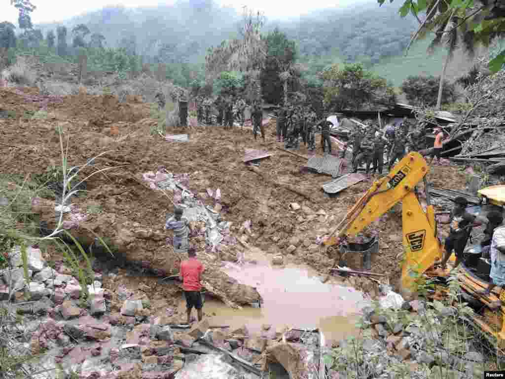 Rescue teams from the Sri Lankan military engage in a rescue operation at the site of a landslide at the Koslanda tea plantation in Badulla, Sri Lanka, Oct. 29, 2014.