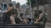Des membres du M23 en patrouille dans les rues de Goma en RDC.