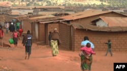 FILE - Refugees of various nationalities walk through the Dzaleka refugee camp, Dowa district, in Malawi's central region, June 20, 2018.