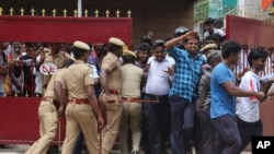 India Film Kabali: Policemen try to maintain the order of the fans of Indian superstar Rajinikanth as they enter the premises of a cinema hall where the actor's new movie "Kabali" is being screened in Chennai, India, Friday, July 22, 2016.