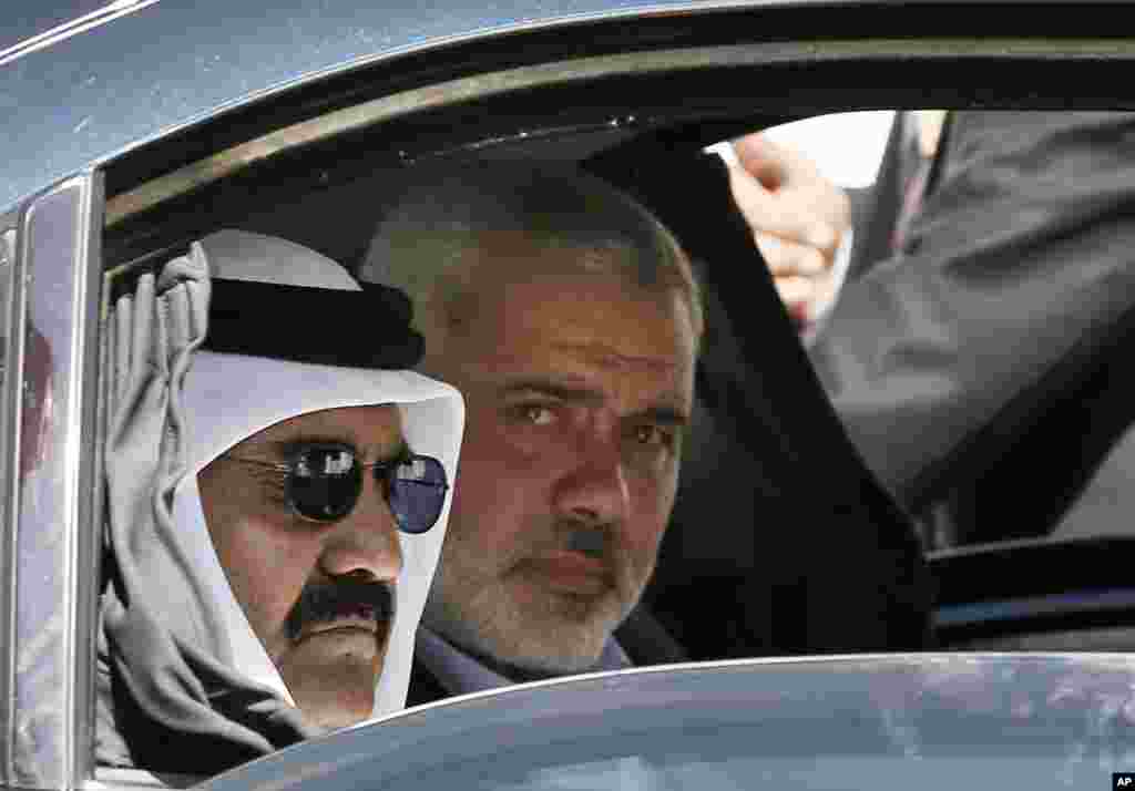 Emir of Qatar Sheikh Hamad bin Khalifa al-Thani, left, and Gaza's Hamas prime minister Ismail Haniyeh, right, arrive for the corner-stone laying ceremony for Hamad, a new residential neighborhood in Khan Younis, southern Gaza Strip October 23, 2012.