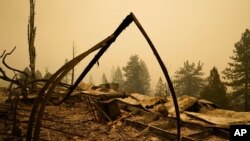 Property is left in ruins after the Creek Fire passed through, Sept. 8, 2020, in Tollhouse, Calif. 