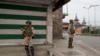 Indian paramilitary soldiers stand guard at a market in Srinagar, Indian-controlled Kashmir, July 13, 2019.