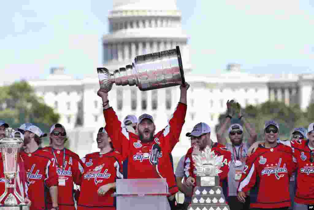 Washington Capitals' Alex Ovechkin of Russia holds up the Stanley Cup trophy during the NHL hockey team's Stanley Cup victory celebration at the National Mall in Washington.