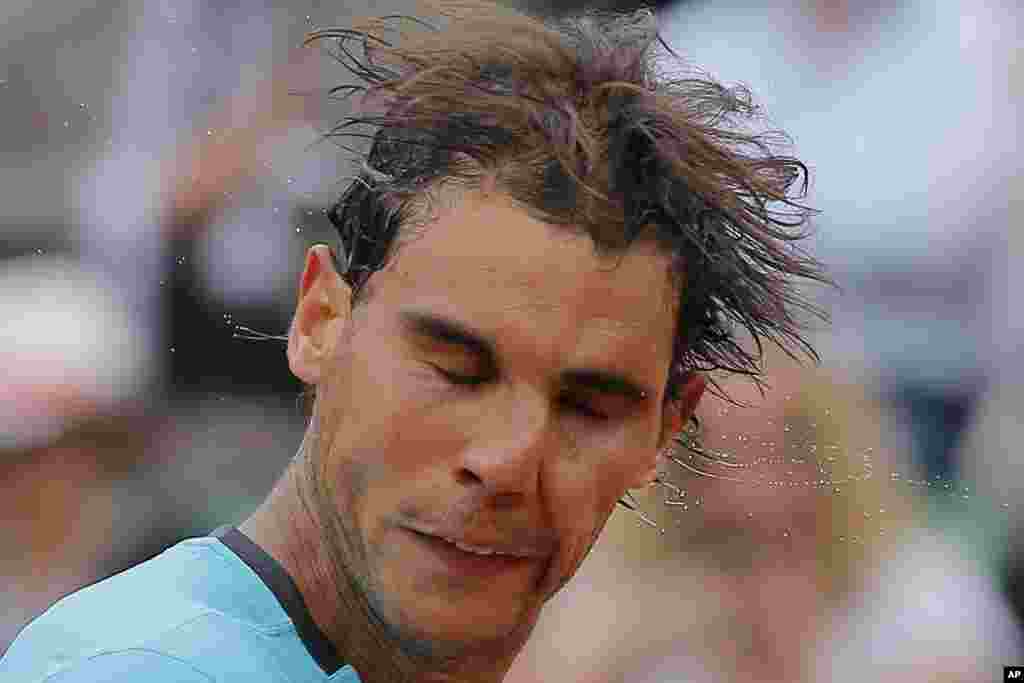 Spain's Rafael Nadal shakes the sweat off his head after winning his fourth round match of the French Open tennis tournament against Serbia's Dusan Lajovic at the Roland Garros stadium, in Paris, France. Nadal won in three sets 6-1, 6-2, 6-1.