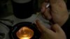 FILE - Qin Jinzhou deposits an embryo into a microplate after injecting it with Cas9 protein and PCSK9 sgRNA in a laboratory in Shenzhen in southern China's Guangdong province, Oct. 9, 2018.