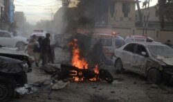 Pakistani rescue workers and volunteers help to remove victims at the site of a suicide bombing in Quetta, Feb. 17, 2020.