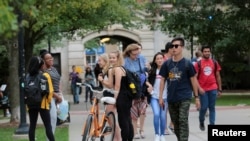 FILE - Students walk on campus at the University of Michigan in Ann Arbor, Michigan, Sept. 19, 2018.
