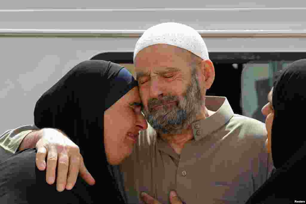 Abu Qatada's father and a family member wait for his release after his acquittal is announced, Amman, Sept. 24, 2014.