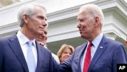 FILE - President Joe Biden speaks with Sen. Rob Portman, R-Ohio, left, and other senators outside the White House in Washington, June 24, 2021.