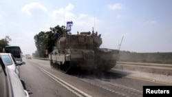 Kifaru cha Israel kikipita barabarani kufuatia kupenya kwa watu wengi wenye silaha kutoka kwa Hamas Ukanda wa Gaza, karibu na Sderot.