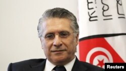 In this file picture taken on Aug. 2, 2019, Nabil Karoui, Tunisian media magnate and would-be presidential candidate submits his candidacy to Tunisia's electoral commission in the capital Tunis. 