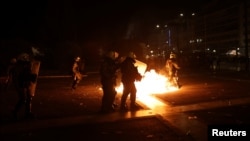 Protesters clash with police during an Athens, Greece, rally about a deadly 2023 train crash, March 7, 2025. 