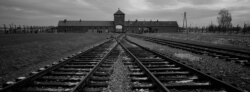 FILE - The railway tracks from where hundreds of thousands of people were directed to the gas chambers to be murdered, inside the former Nazi death camp of Auschwitz Birkenau, in Oswiecim, Poland, Dec. 7, 2019.