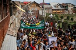 FILE - Kashmiri men shout slogans during a protest after the scrapping of the special constitutional status for Kashmir by the Indian government, in Srinagar, Aug. 11, 2019.