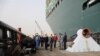 Oussama Rabieh, chairman of the Suez Canal Authority, monitors the situation near the stranded container ship Ever Given after it ran aground, in Suez Canal, Egypt, March 25, 2021. 
