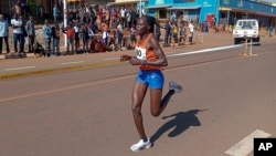 FILE - Rebecca Cheptegei competes at a 10 km road race in Kapchorwa, Uganda, Jan. 20, 2023.