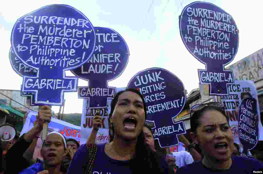 Members of the Gabriela Women's Party, a group advocating the rights of Filipino women, shout, "Justice for slain transgender Jennifer Laude" during a protest outside the Justice Hall, where preliminary investigations into Jennifer Laude's murder were being held, in Olongapo city, north of Manila, Oct. 21, 2014.