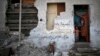 A Palestinian boy looks out of his family house, which witnesses said was damaged during Israel's seven-week offensive, Beit Hanoun, the northern Gaza Strip, Oct. 8, 2014.