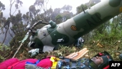 Chris Kasaija, a senior Ugandan Airforce pilot, is rescued on August 14, 2012 in Nanyuki from the wreckage of his helicopter. (Photo AFP / Handout)