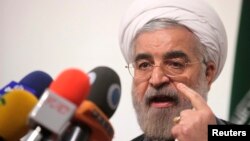 FILE - Iranian presidential candidate Hassan Rowhani, Iran's former top nuclear negotiator, speaks during a campaign rally in Tehran, May 30, 2013.