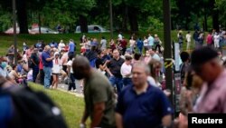 FILE - Hundreds of people line up outside a Kentucky Career Center hoping to find assistance with their unemployment claim in Frankfort, Kentucky, June 18, 2020. 