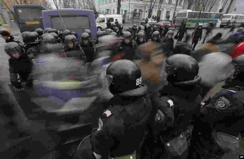 Pro-European Union activists pass through a police line as they march against the government in Kyiv, Dec. 17, 2013.